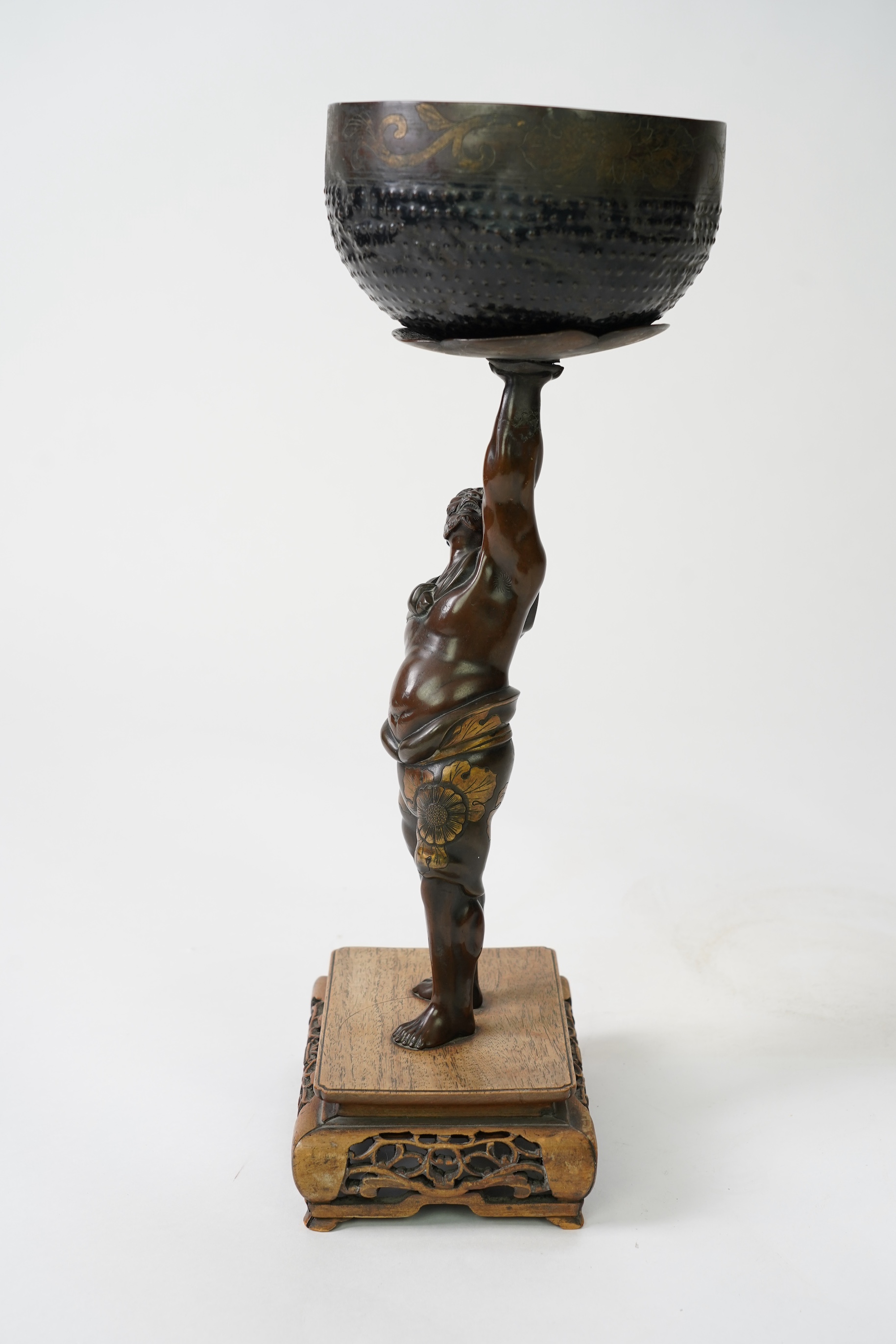 A Japanese bronze figure of an Oni holding a temple bell aloft, Meiji period, in Miyao style